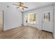 Cozy living room featuring wood floors, natural light, and a white entry door at 17153 Se 79Th Street Rd, Ocklawaha, FL 32179