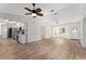 Open-concept living room with wood floors, connecting to the kitchen with modern appliances at 17153 Se 79Th Street Rd, Ocklawaha, FL 32179