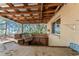 Covered outdoor kitchen area with a built-in grill, tiled backsplash, and bar countertop at 17153 Se 79Th Street Rd, Ocklawaha, FL 32179