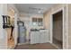 Utility room featuring a water heater and standard washer and dryer appliances at 17153 Se 79Th Street Rd, Ocklawaha, FL 32179