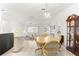 Bright dining area featuring a chandelier and a view into the living room and kitchen at 17421 Se 107Th Ct, Summerfield, FL 34491