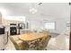 Open-concept dining area showcasing the kitchen, living room, and plenty of natural light at 17421 Se 107Th Ct, Summerfield, FL 34491