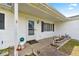 Charming front porch features white siding, decorative accents, and a welcoming entrance, creating a cozy curb appeal at 17421 Se 107Th Ct, Summerfield, FL 34491