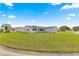 Expansive front yard displaying lush green grass and a well-kept lawn at 17421 Se 107Th Ct, Summerfield, FL 34491