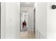 Hallway showcasing access to other rooms, with neutral tile flooring and bright lighting for a welcoming ambiance at 17421 Se 107Th Ct, Summerfield, FL 34491