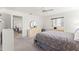 Bright main bedroom featuring neutral carpeting, a ceiling fan, and ample natural light from one window at 17421 Se 107Th Ct, Summerfield, FL 34491