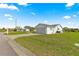 Well-maintained lawn around a house with an attached garage at 17421 Se 107Th Ct, Summerfield, FL 34491