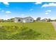 Side yard features lush green grass extending to the street and neighboring homes at 17421 Se 107Th Ct, Summerfield, FL 34491