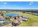 Bird's eye view of the house in a golf community, featuring a serene pond and well-kept greenery at 17818 Se 120Th Ct, Summerfield, FL 34491