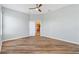 Bedroom featuring a ceiling fan, ample space, and wood-look flooring at 17818 Se 120Th Ct, Summerfield, FL 34491