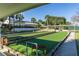 Bocce Ball court with palm trees with an outdoor shelter and nearby clubhouse at 17818 Se 120Th Ct, Summerfield, FL 34491