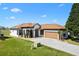 Beautiful single-story home features a manicured lawn, neutral paint scheme, and an attached two-car garage at 17818 Se 120Th Ct, Summerfield, FL 34491