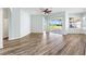 Open living space featuring wood floors and sliding glass doors to the lanai at 17818 Se 120Th Ct, Summerfield, FL 34491