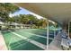 Outdoor shuffleboard courts with covered seating, offering a recreational amenity for residents and guests at 17818 Se 120Th Ct, Summerfield, FL 34491