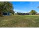 Spacious backyard view showcasing lush lawn and a versatile shed, ideal for storage or hobbies at 1905 Nw 25Th Ave, Ocala, FL 34475