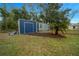 Outdoor storage shed on a lush green lot providing ample space for hobbies or storage of recreational vehicles at 1905 Nw 25Th Ave, Ocala, FL 34475