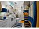 Stylish bathroom with a white vanity, round mirror, and decorative blue light fixture, creating a modern and inviting space at 1905 Nw 25Th Ave, Ocala, FL 34475