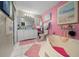 Pink bathroom featuring a tub, double vanity, beach art, and decor at 1905 Nw 25Th Ave, Ocala, FL 34475