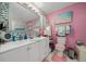 Bright bathroom featuring a double vanity, beach-themed decor, and pink accents at 1905 Nw 25Th Ave, Ocala, FL 34475