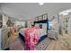 Spacious bedroom featuring a blue plush bed, flamingo-themed decor and light-colored wood-look floors at 1905 Nw 25Th Ave, Ocala, FL 34475