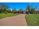 A view of the attractive home showcasing a spacious yard, long driveway, and inviting exterior at 1905 Nw 25Th Ave, Ocala, FL 34475