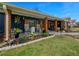 Charming front porch with rocking chairs, decorative shutters, and colorful landscaping at 1905 Nw 25Th Ave, Ocala, FL 34475