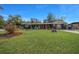 A cozy blue home featuring a well-maintained lawn, rocking chair front porch and wood accent shutters at 1905 Nw 25Th Ave, Ocala, FL 34475