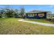 Exterior view of the home showing well-manicured lawn and tasteful landscaping with garden decorations on a sunny day at 1905 Nw 25Th Ave, Ocala, FL 34475