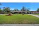 A cozy blue home featuring a well-maintained lawn, rocking chair front porch and wood accent shutters at 1905 Nw 25Th Ave, Ocala, FL 34475