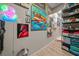 Hallway with flamingo art, colorful accents and decorative shelving leading into the home at 1905 Nw 25Th Ave, Ocala, FL 34475