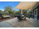 Backyard patio featuring a dining set, shade sail, and landscaped surroundings, perfect for outdoor entertaining and relaxation at 1905 Nw 25Th Ave, Ocala, FL 34475