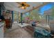 Inviting sunroom with plush sofa, ceiling fan, and natural light, creating a comfortable and relaxing atmosphere at 1905 Nw 25Th Ave, Ocala, FL 34475