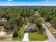 This aerial view captures the house, showing the driveway and a well-manicured lawn at 20396 Sw 79Th Lane, Dunnellon, FL 34431