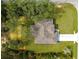 Aerial shot of the home showing its roof, driveway, and surrounding landscape with mature trees at 20396 Sw 79Th Lane, Dunnellon, FL 34431