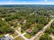 This aerial shot shows the property nestled among lush trees in a residential neighborhood at 20396 Sw 79Th Lane, Dunnellon, FL 34431