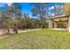 This backyard features plenty of green space and mature trees, offering privacy and tranquility at 20396 Sw 79Th Lane, Dunnellon, FL 34431