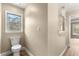 Powder room featuring a tiled shower, modern toilet, wood-look floor, and neutral colors at 20396 Sw 79Th Lane, Dunnellon, FL 34431