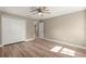 Bedroom with a ceiling fan, wood-look floors, a closet, and neutral paint at 20396 Sw 79Th Lane, Dunnellon, FL 34431