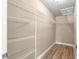 Walk-in closet with ample wire shelving and wood-look flooring at 20396 Sw 79Th Lane, Dunnellon, FL 34431