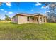 The home's exterior view features a stucco exterior, a covered patio, and a well-maintained lawn at 20396 Sw 79Th Lane, Dunnellon, FL 34431