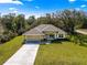 Charming single-story home featuring a well-manicured lawn and a two-car garage with a long driveway at 20396 Sw 79Th Lane, Dunnellon, FL 34431