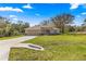 Inviting single-story home with a well-maintained lawn, a two-car garage, and a cozy front porch at 20396 Sw 79Th Lane, Dunnellon, FL 34431