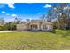 Attractive single-story home featuring a manicured lawn and an attached two-car garage with stone accents at 20396 Sw 79Th Lane, Dunnellon, FL 34431