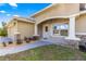 Covered front porch featuring stone columns, manicured landscaping, and a welcoming entrance at 20396 Sw 79Th Lane, Dunnellon, FL 34431