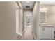 Hallway featuring wood-look floors leading to a bathroom with a white vanity at 20396 Sw 79Th Lane, Dunnellon, FL 34431