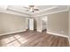 Main bedroom with ensuite bathroom entrance, tray ceiling and ceiling fan at 20396 Sw 79Th Lane, Dunnellon, FL 34431