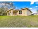 Backyard view with a covered patio, perfect for outdoor entertaining, with lush green grass at 20396 Sw 79Th Lane, Dunnellon, FL 34431