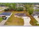 Aerial view of the home featuring a large backyard, driveway, and well-maintained landscaping at 21 Pecan Pass Ter, Ocala, FL 34472