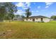 A spacious backyard with a well-maintained lawn and a view of the home's rear exterior at 21 Pecan Pass Ter, Ocala, FL 34472