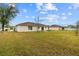 A spacious backyard with a well-maintained lawn and a view of the home's rear exterior at 21 Pecan Pass Ter, Ocala, FL 34472